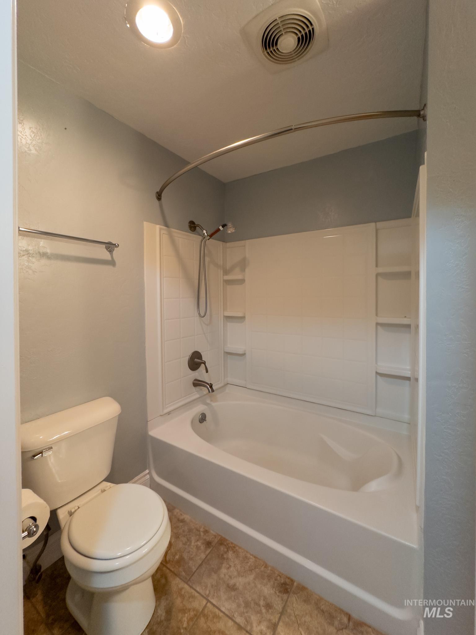 Full bath with shower / bath combination and light tile patterned flooring