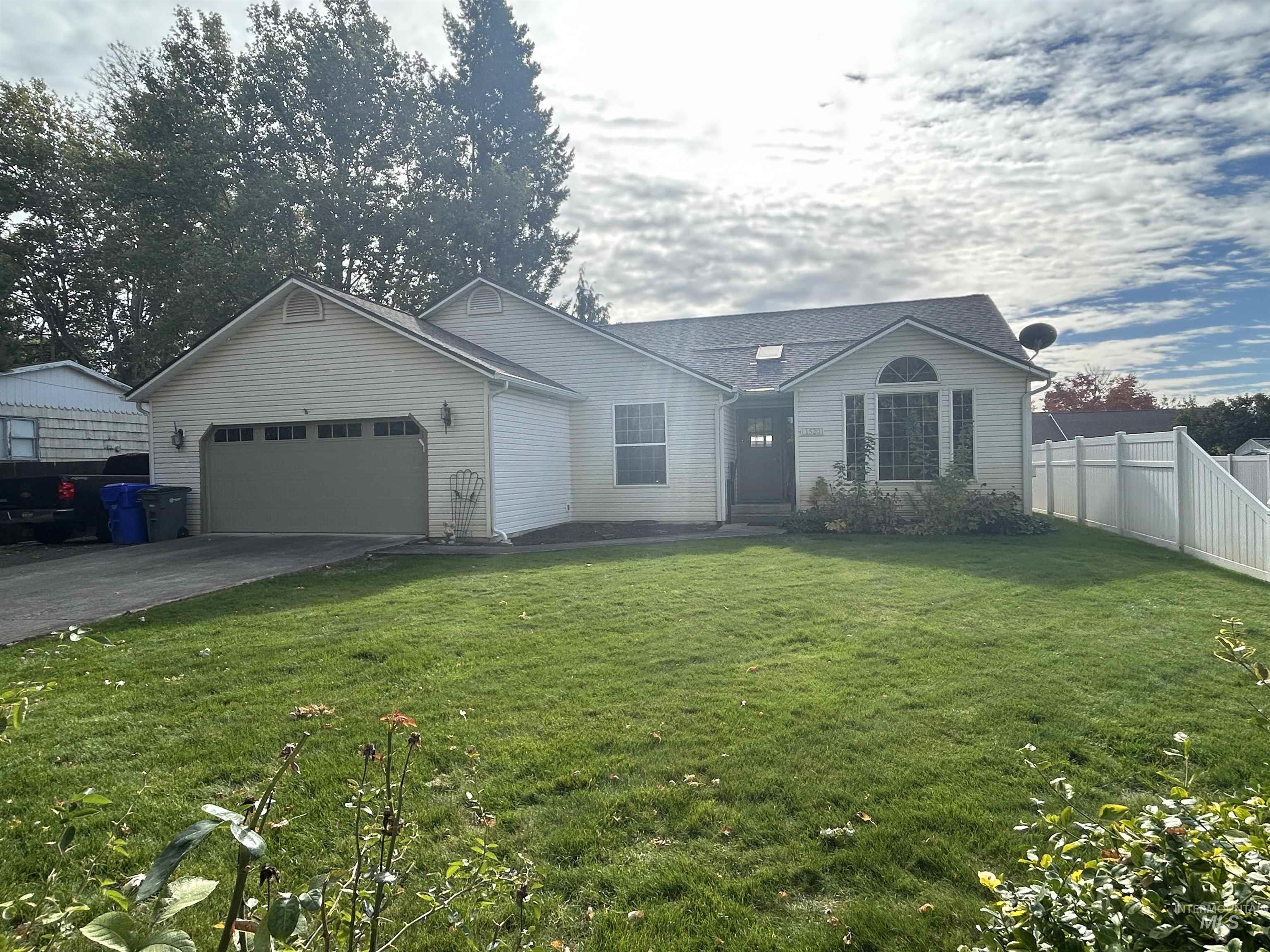 View of front of home with a garage and driveway