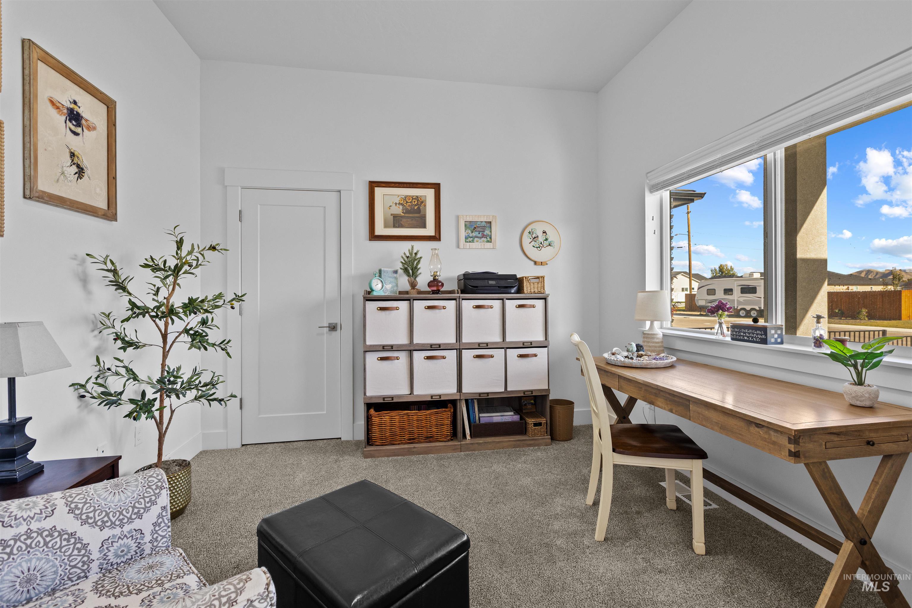 Office featuring light colored carpet and baseboards