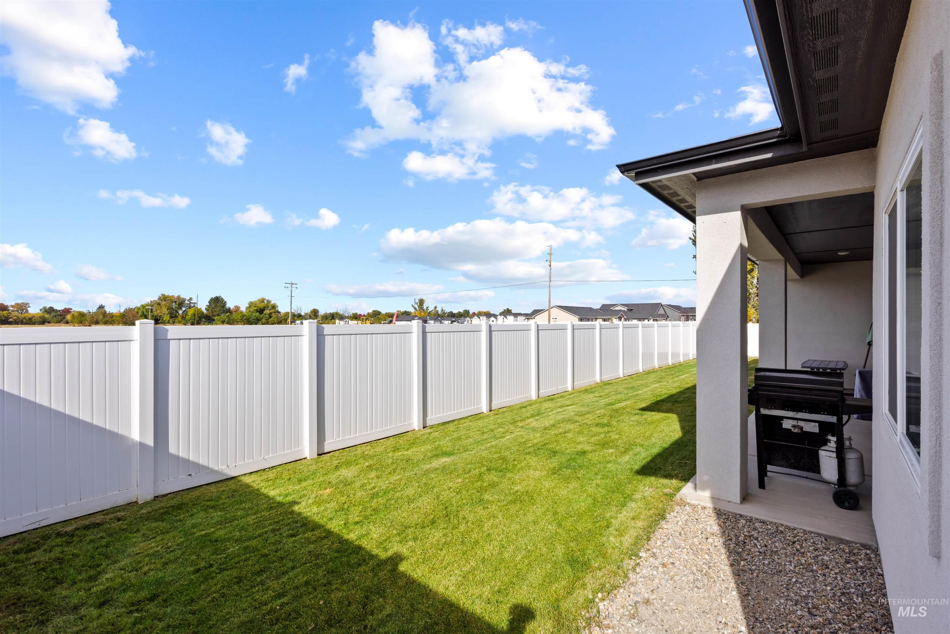Fenced backyard with a patio