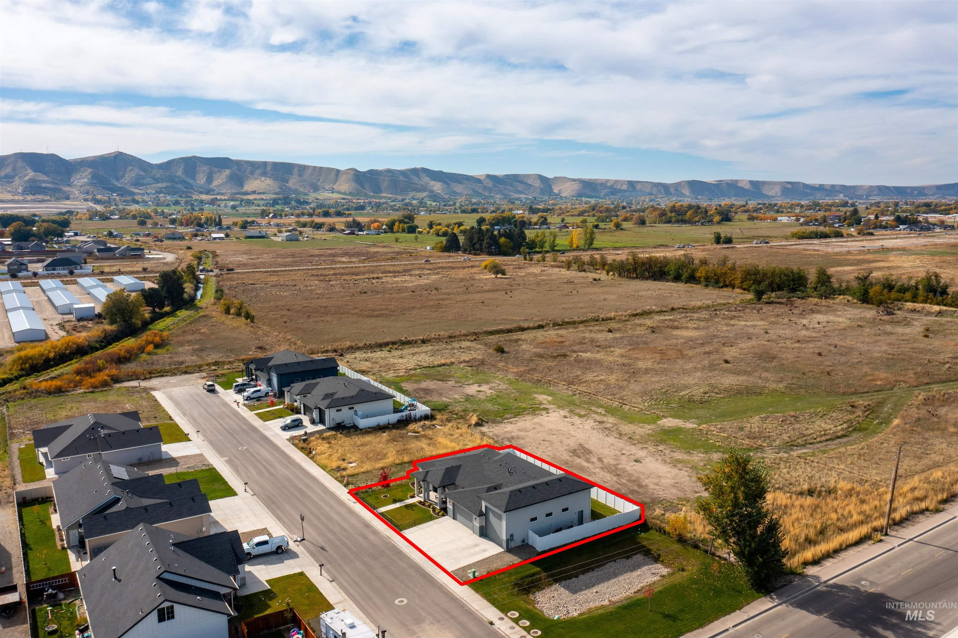 Overview of rural landscape featuring property boundaries highlighted and mountains