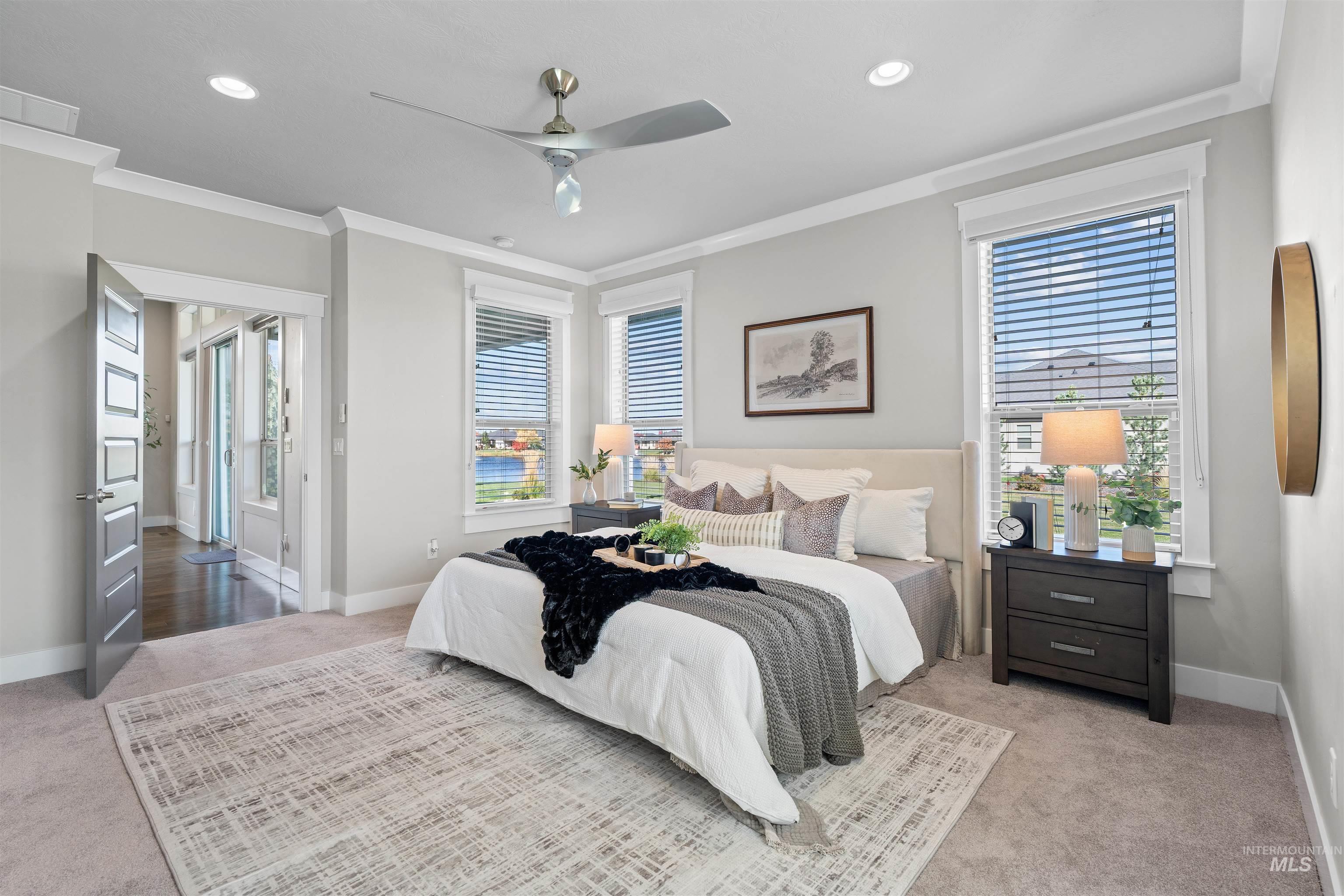 Bedroom with light colored carpet, ceiling fan, ornamental molding, and recessed lighting