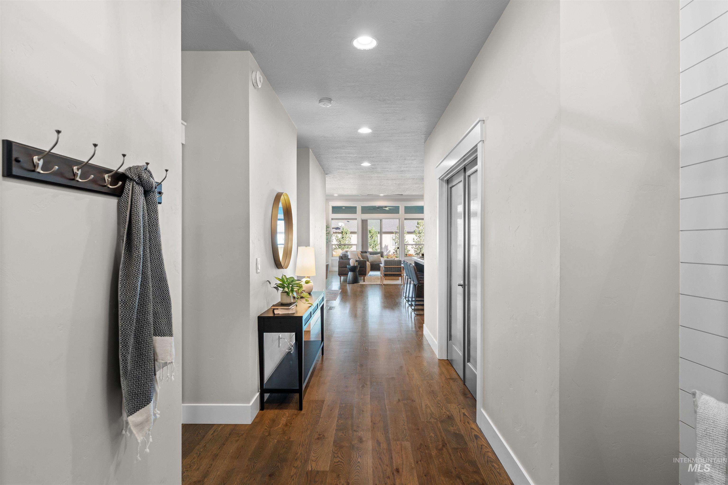 Hall featuring dark wood finished floors and recessed lighting