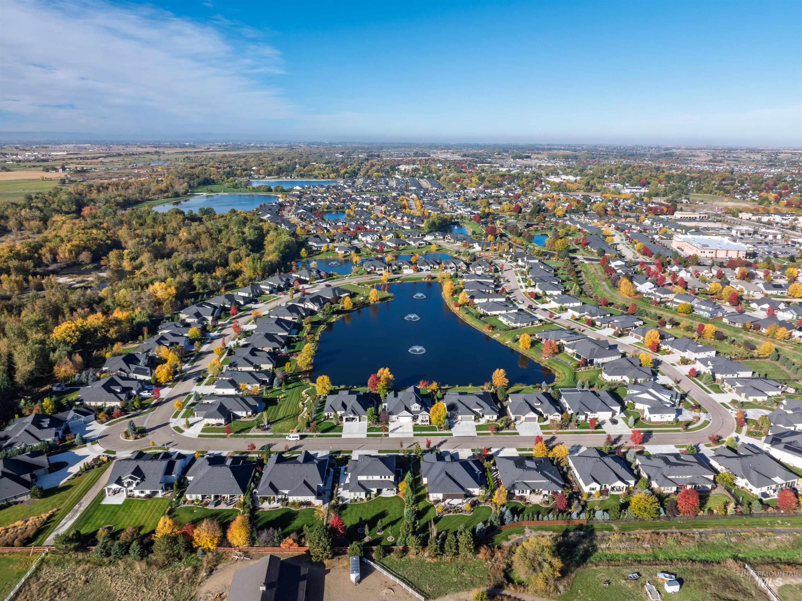 Aerial overview of property's location with a nearby body of water and nearby suburban area