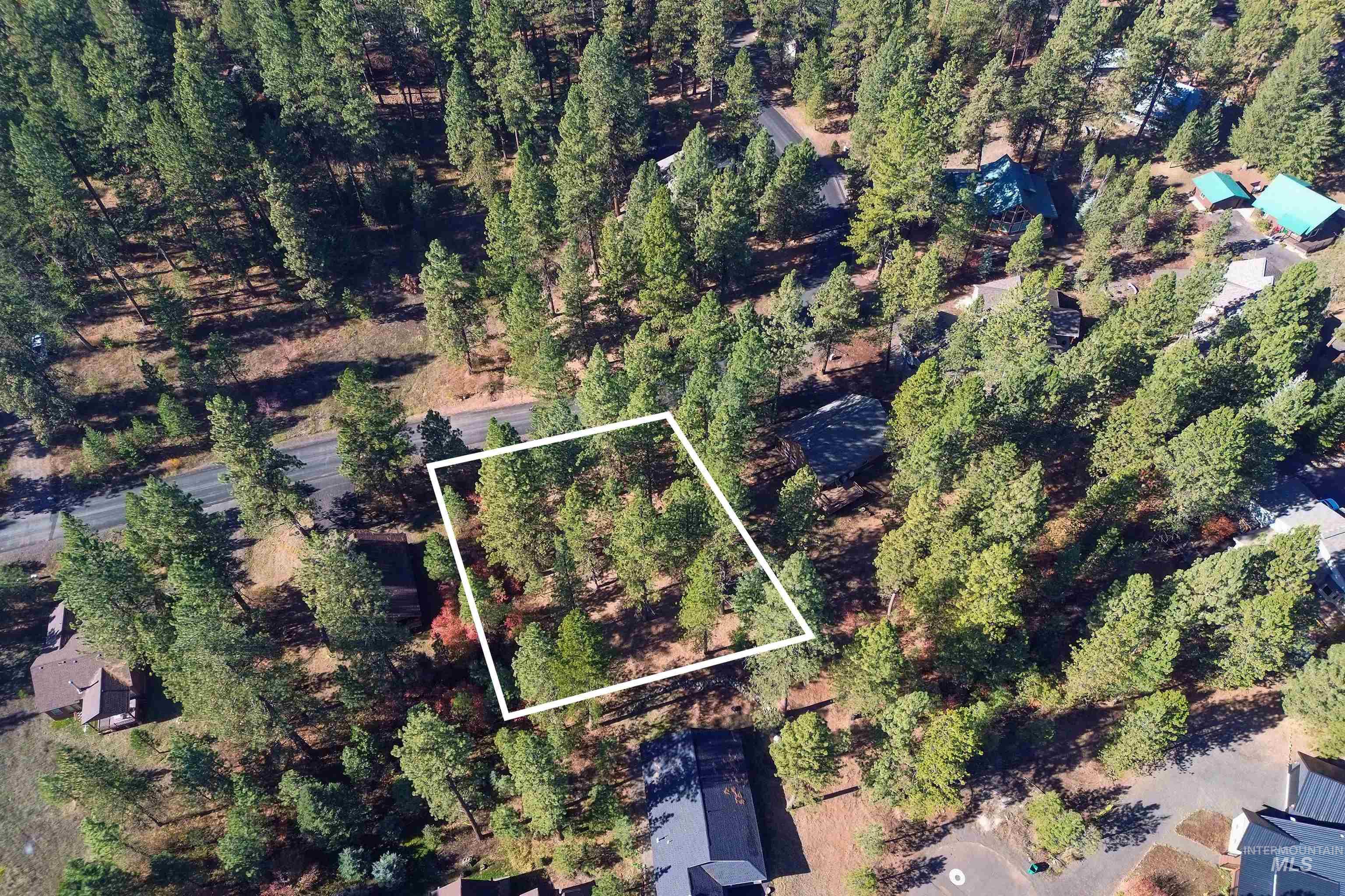 Aerial view of property and surrounding area featuring property boundaries highlighted