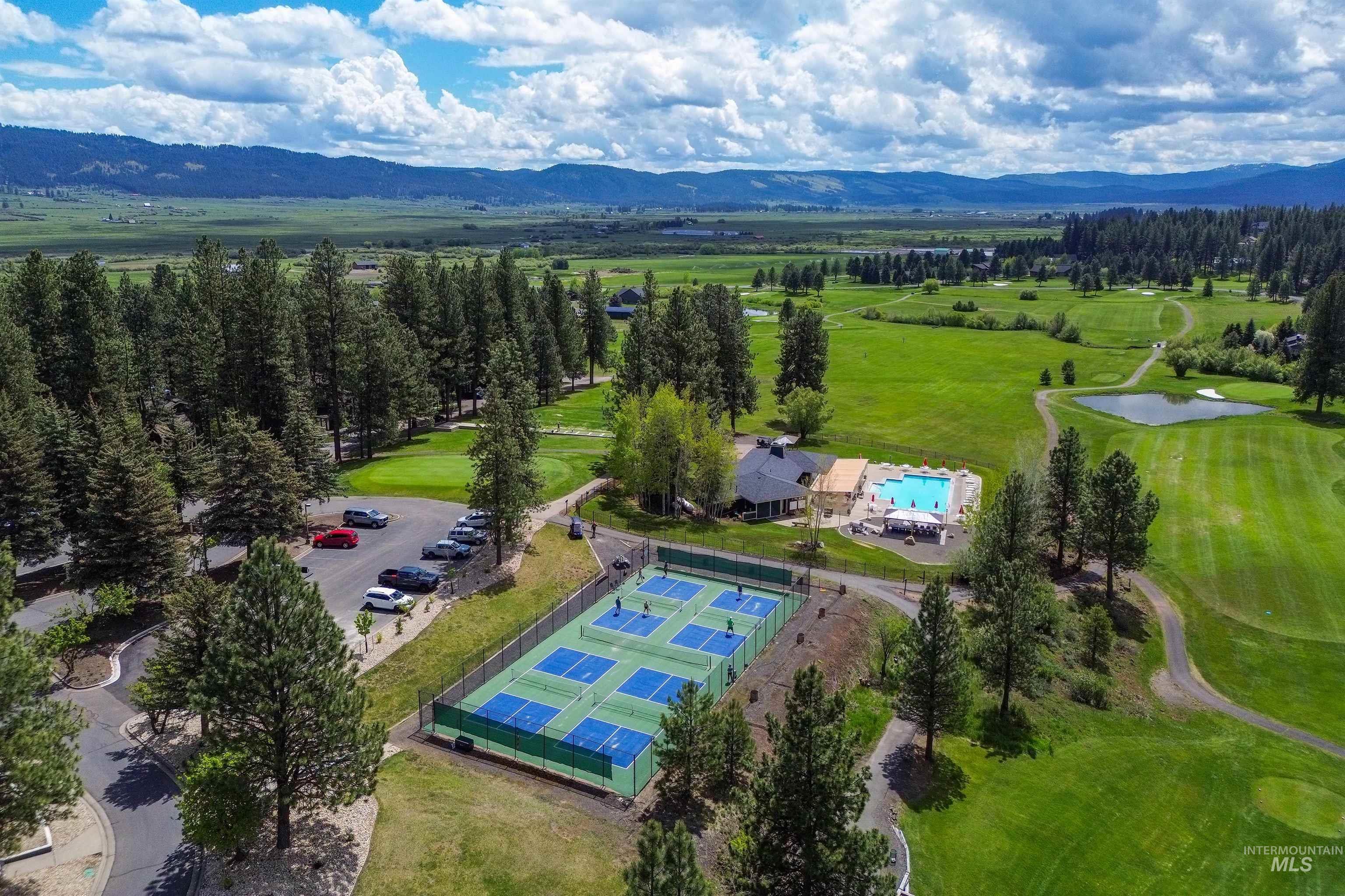 Drone / aerial view of a pool area and a water and mountain view