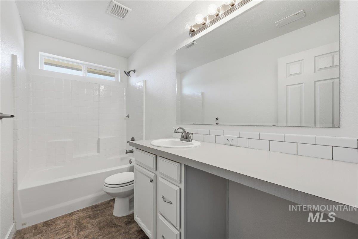 Full bathroom with shower / washtub combination and vanity