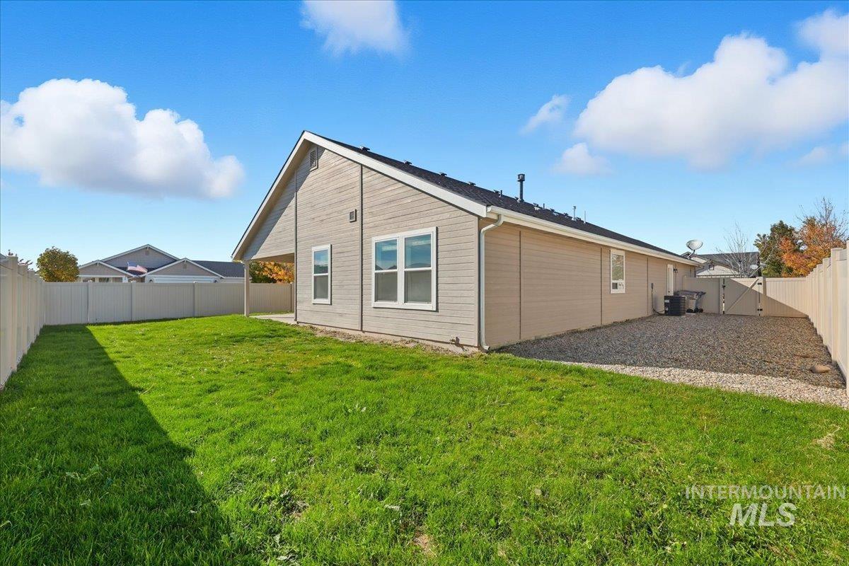 Back of house with a fenced backyard