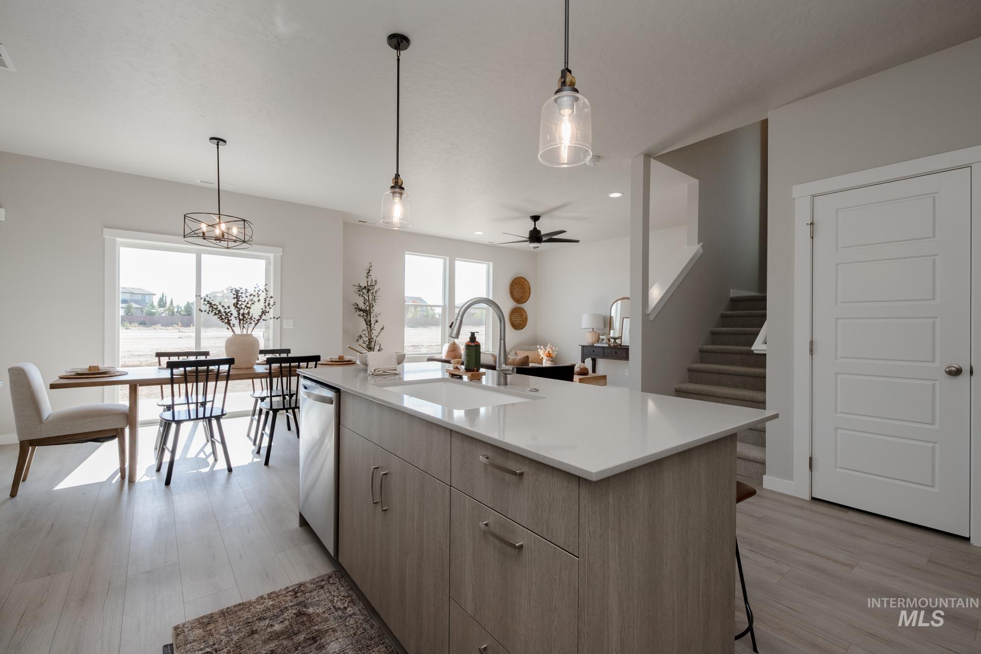 Kitchen with pendant lighting, a kitchen breakfast bar, light wood-style flooring, a kitchen island with sink, and recessed lighting