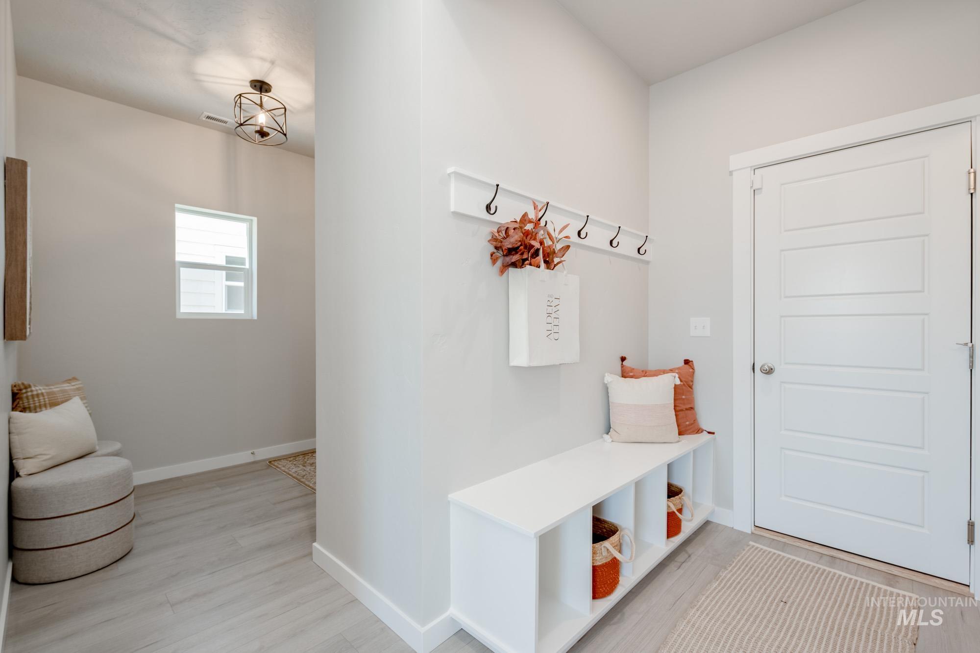 Mudroom featuring light wood-type flooring