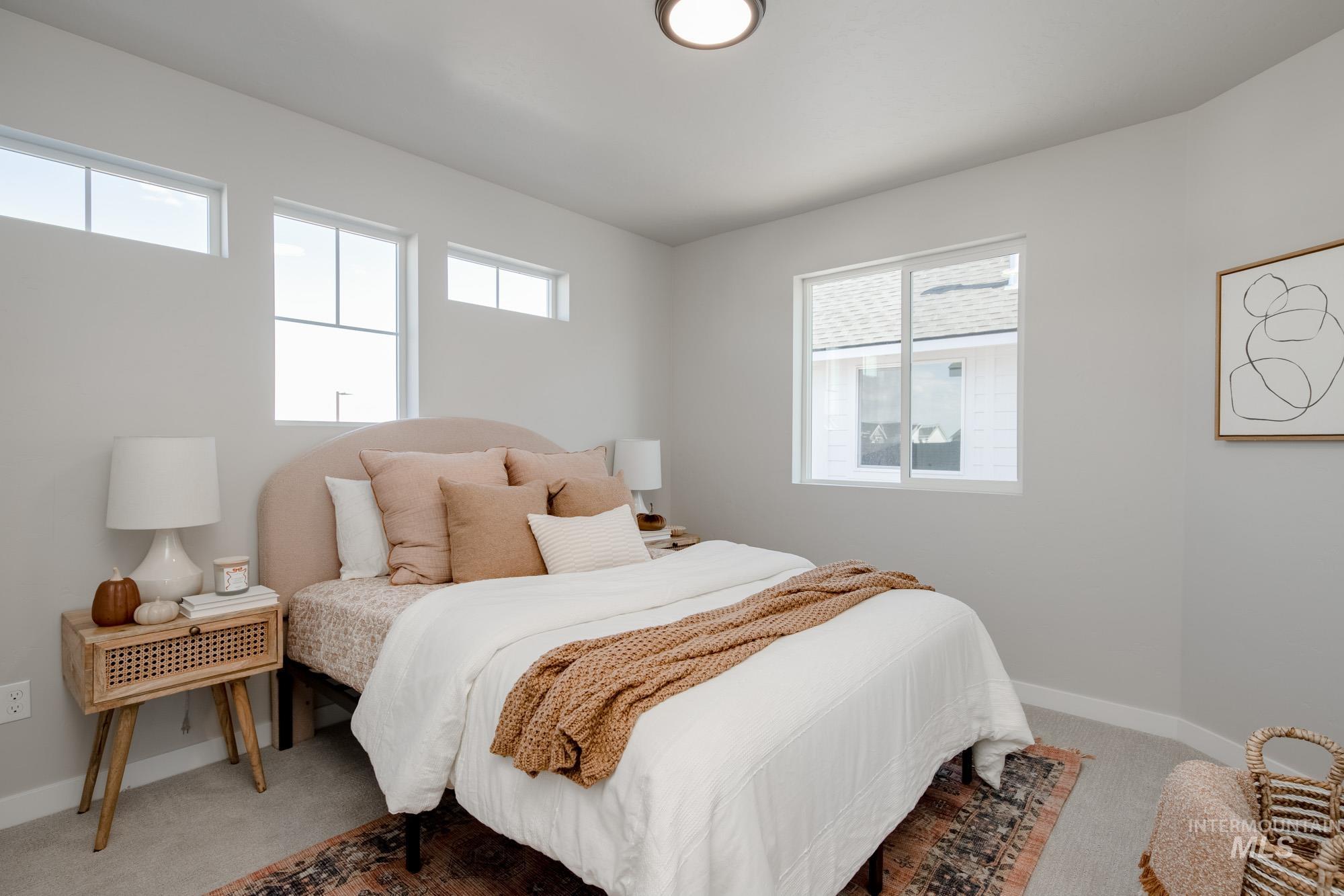 Bedroom featuring light colored carpet and baseboards