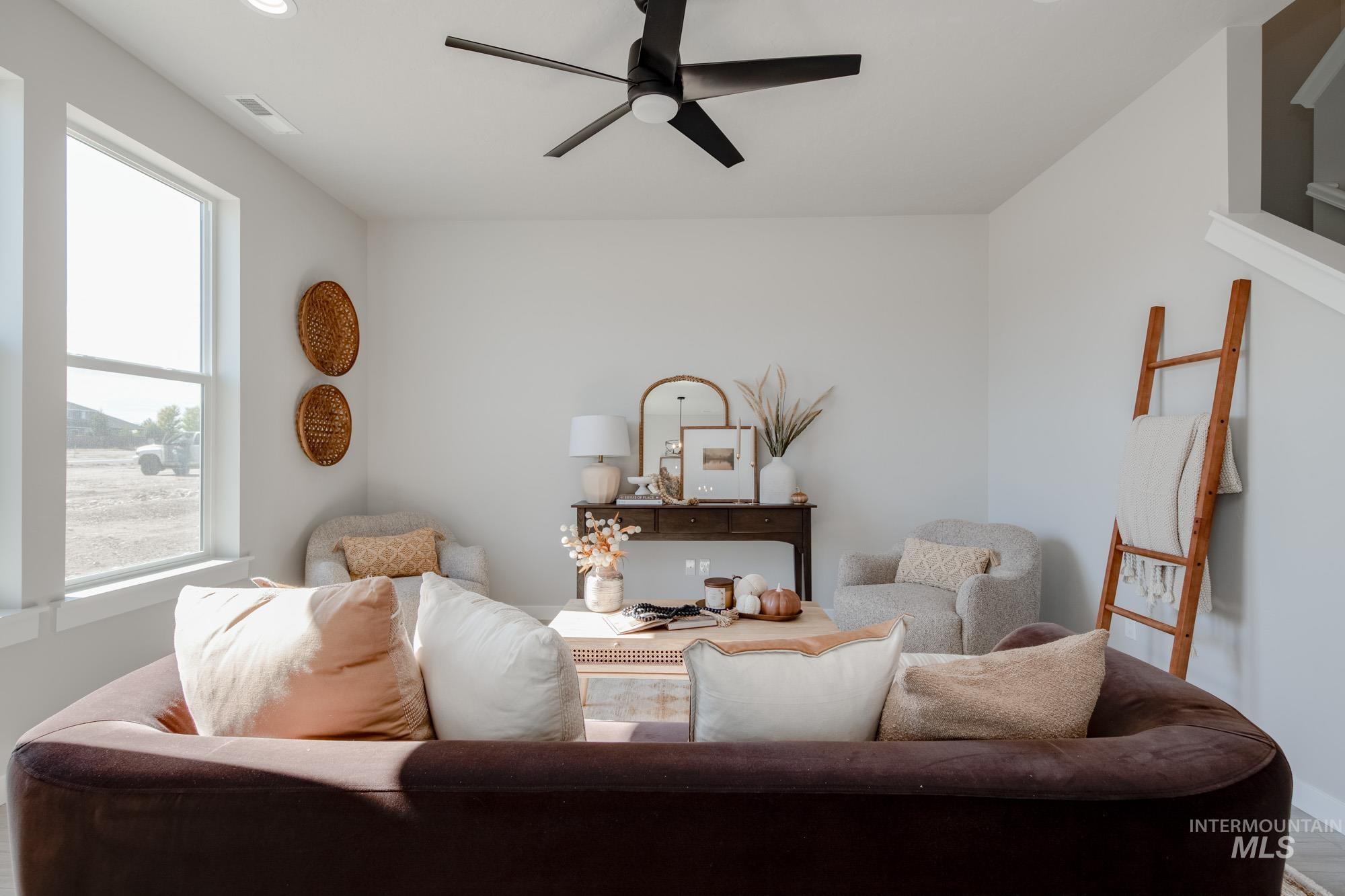 Living area featuring a ceiling fan, recessed lighting, and wood finished floors