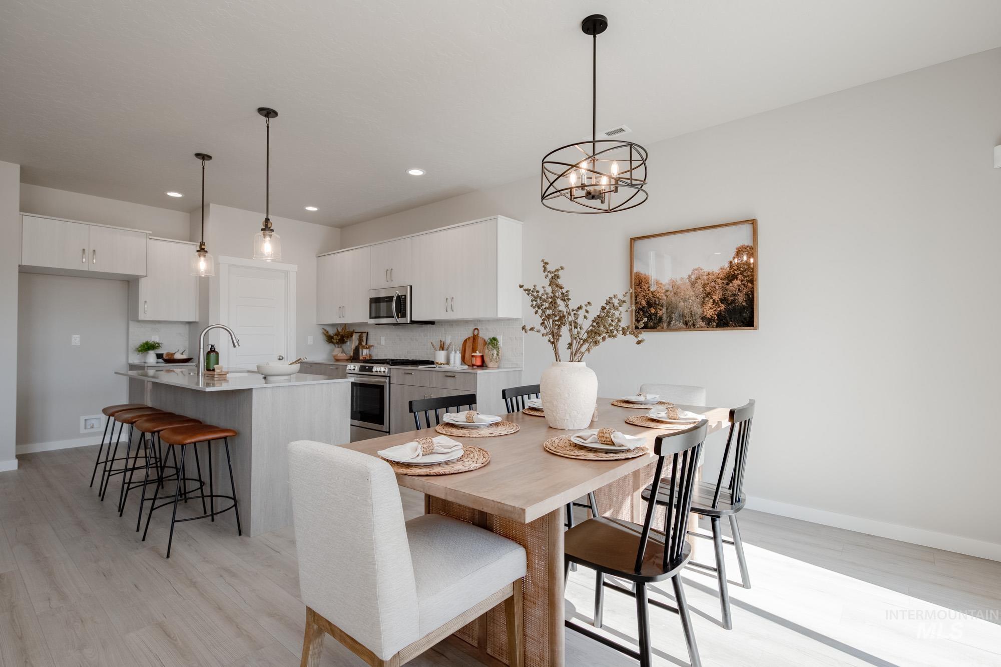Dining room featuring light wood finished floors, a chandelier, and recessed lighting