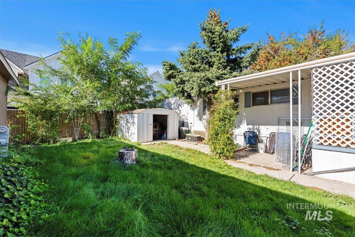 Fenced backyard with a storage shed