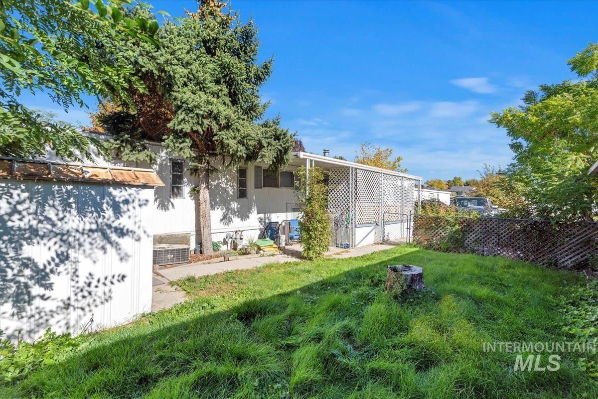 Rear view of house with a fenced backyard and a patio area