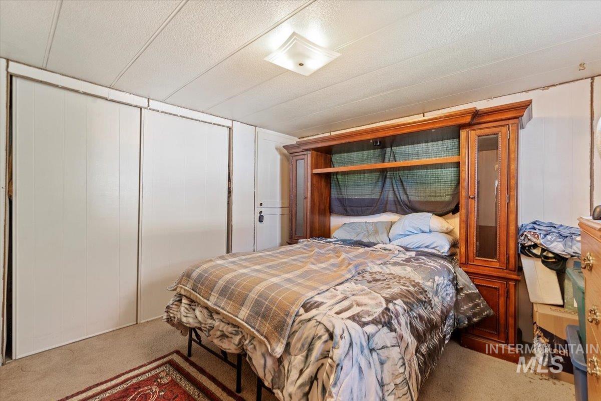 Bedroom featuring carpet and a closet