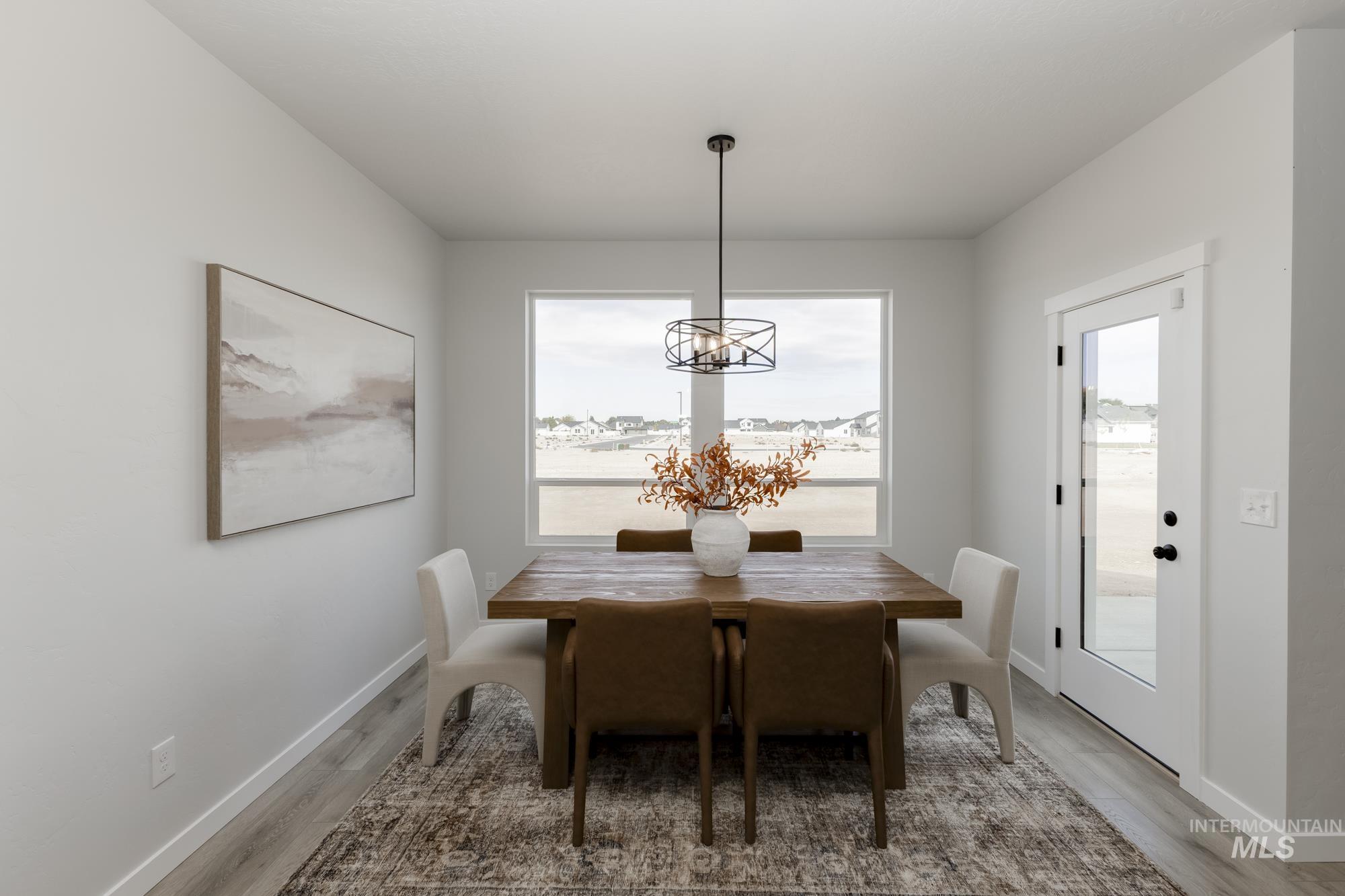 Dining room featuring light wood finished floors and a chandelier