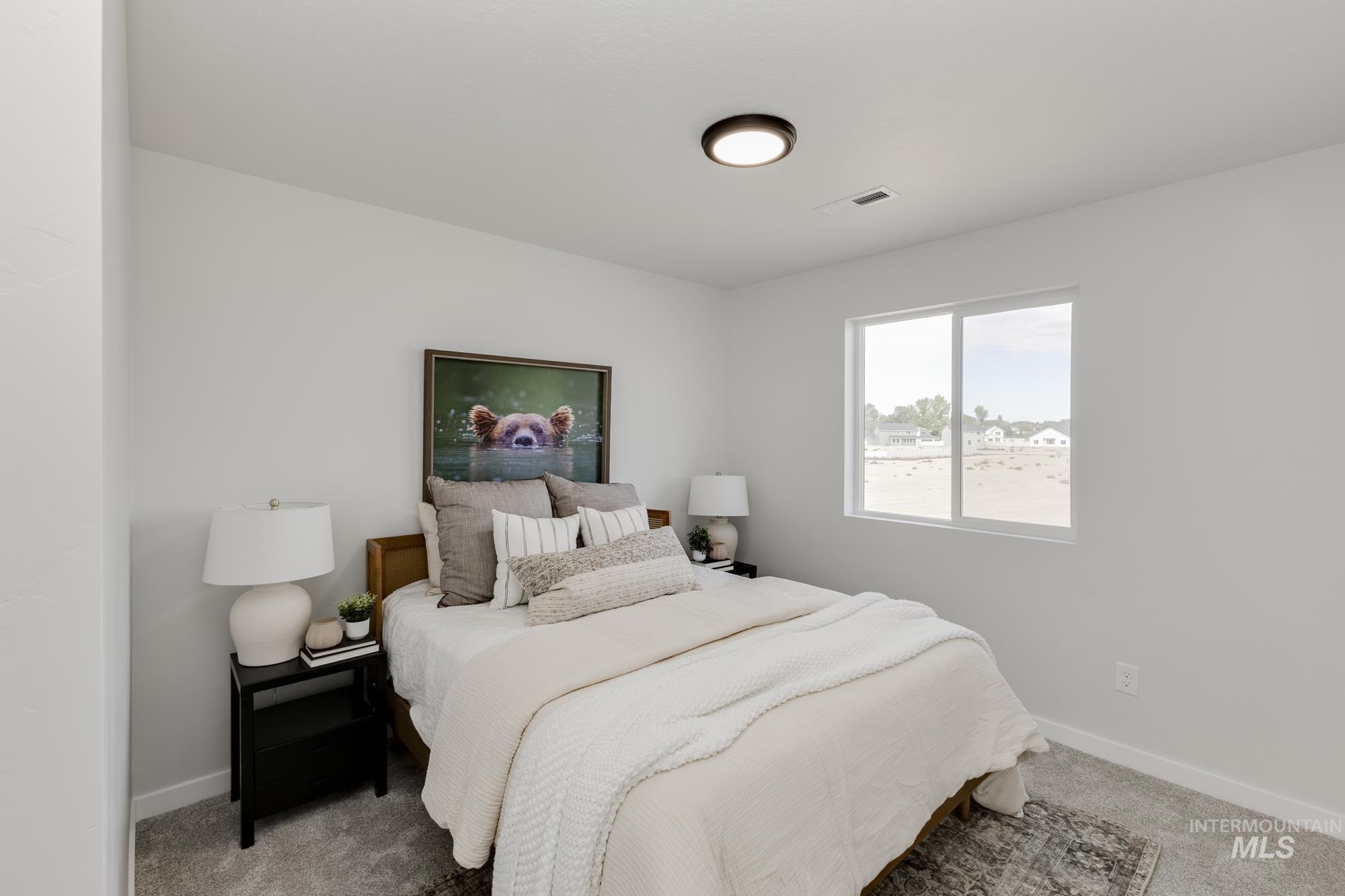 Carpeted bedroom with baseboards