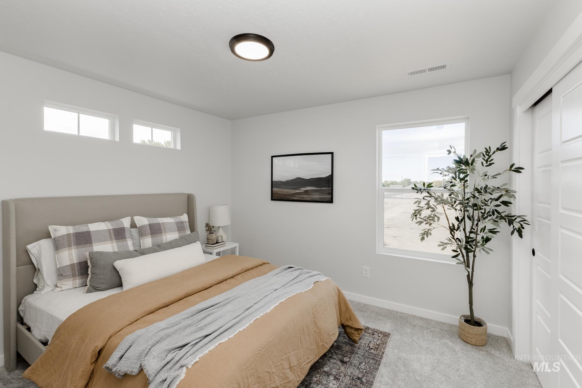 Bedroom featuring baseboards and light colored carpet