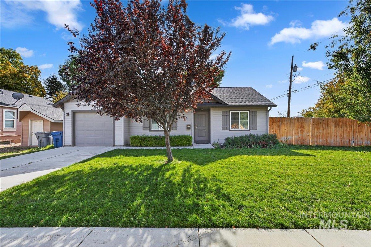 View of front of property with concrete driveway, an attached garage, and roof with shingles