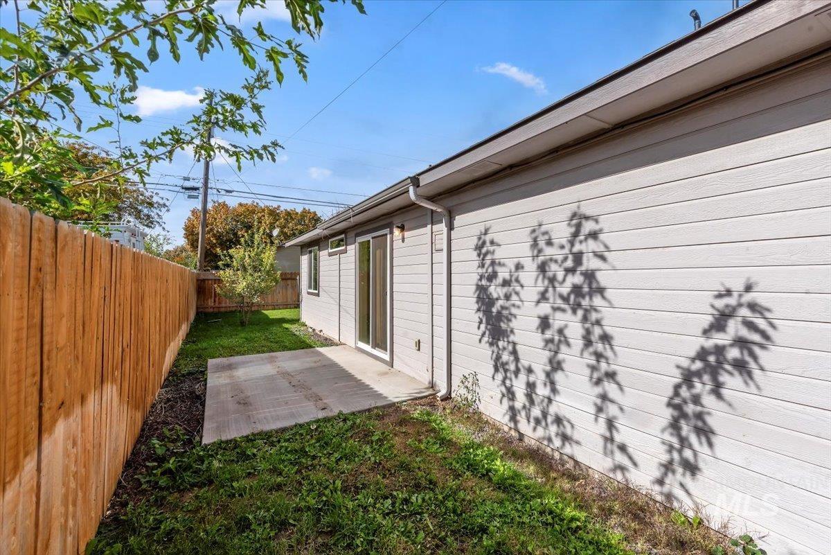 Fenced backyard with a patio area
