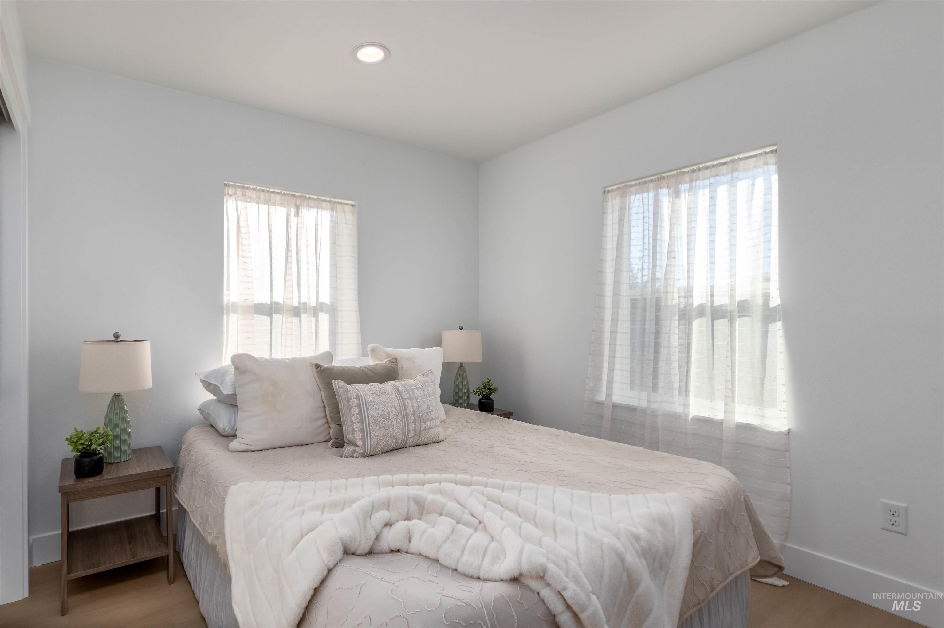 Bedroom featuring wood finished floors and recessed lighting
