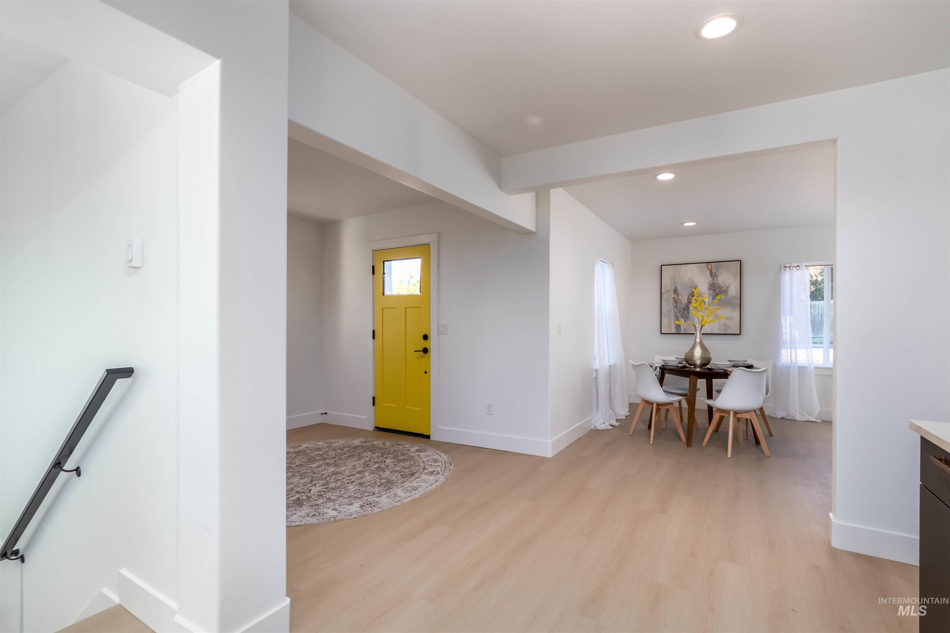 Foyer entrance with recessed lighting and light wood-style flooring