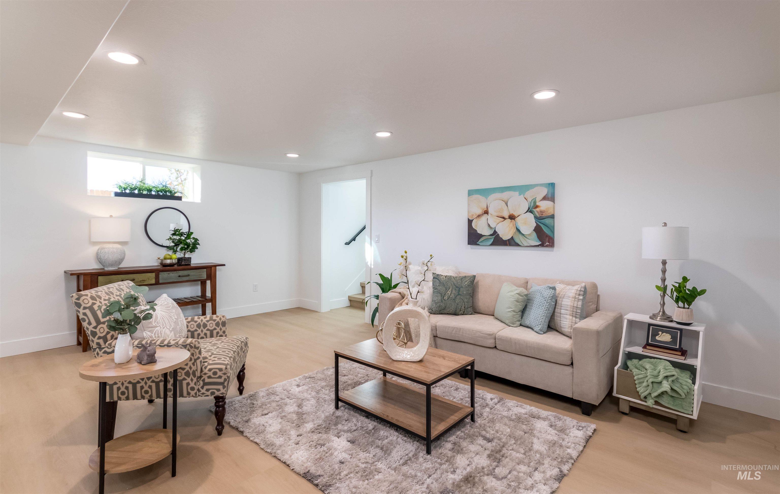 Living area with recessed lighting and light wood finished floors