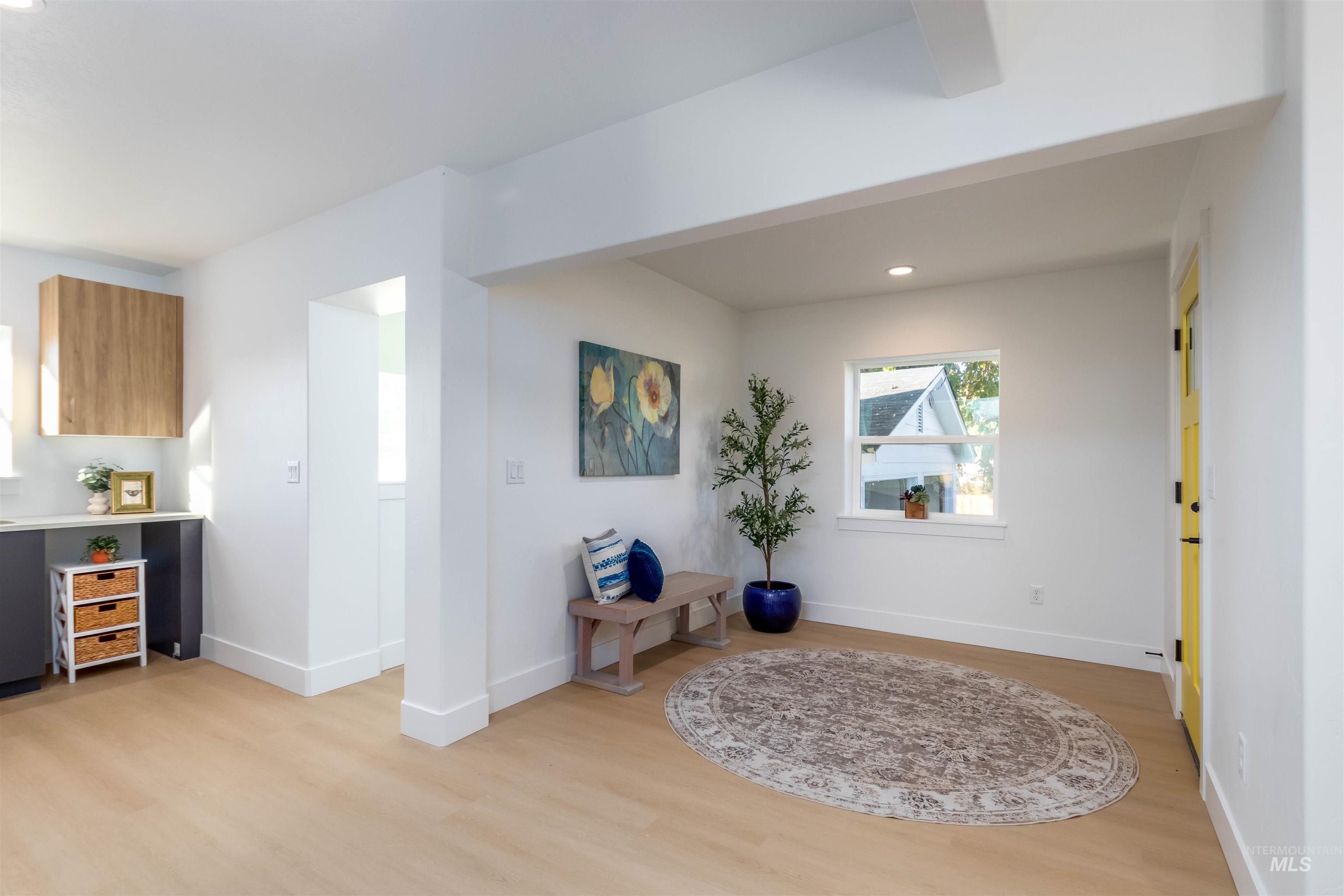 Living area featuring light wood-style flooring and recessed lighting