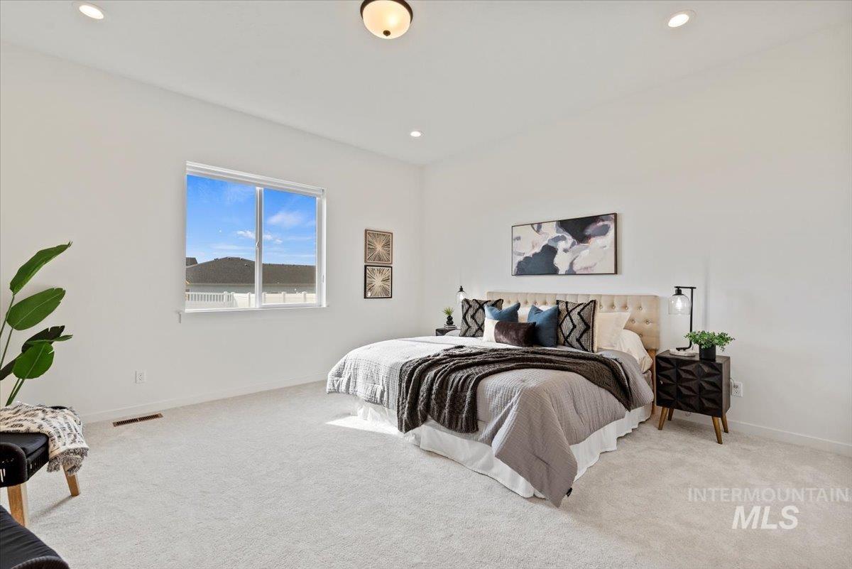 Carpeted bedroom featuring recessed lighting and baseboards