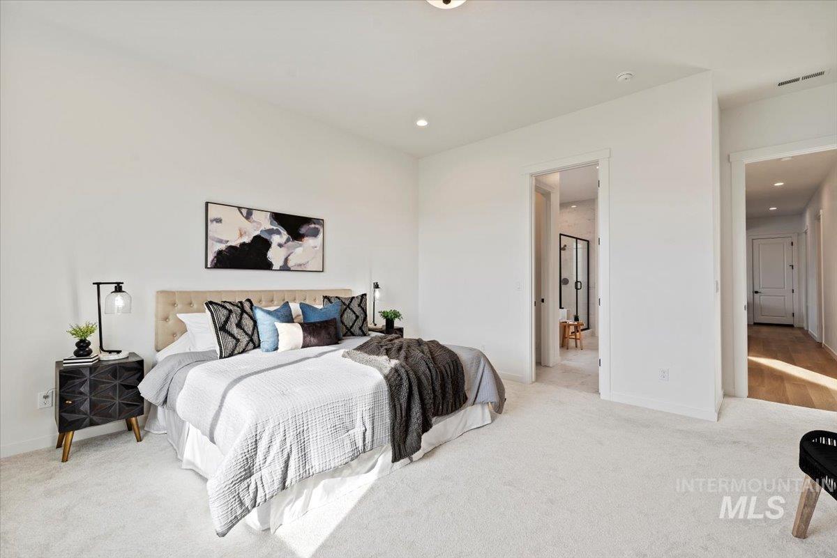 Carpeted bedroom with recessed lighting and baseboards