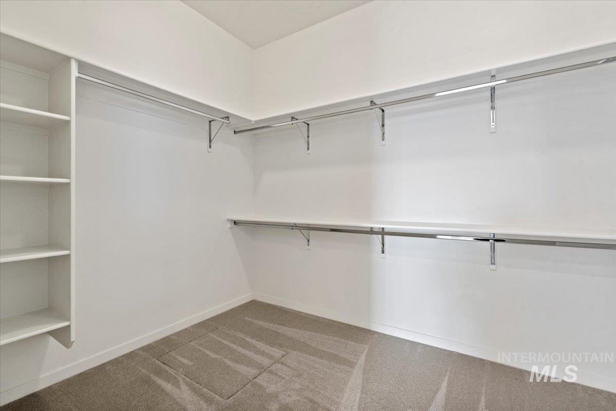 Spacious closet with light colored carpet