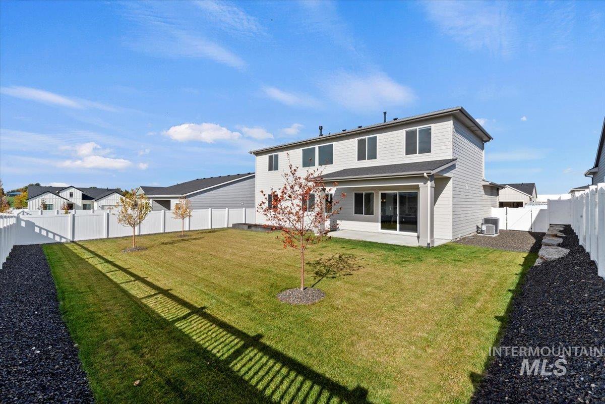 Rear view of property with a fenced backyard, a patio, a residential view, and a gate