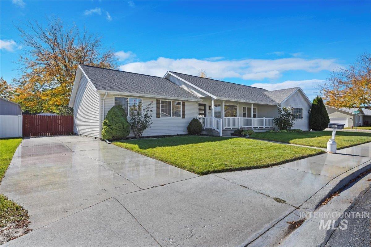 Ranch-style home with a porch, concrete driveway, and a shingled roof