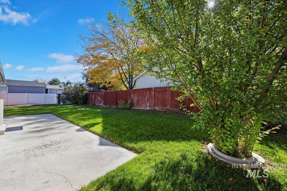Fenced backyard with a patio