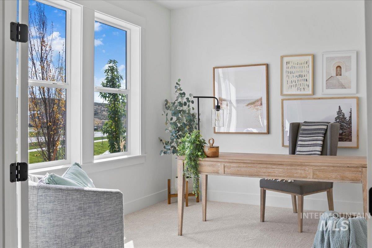 Office space featuring carpet floors and baseboards