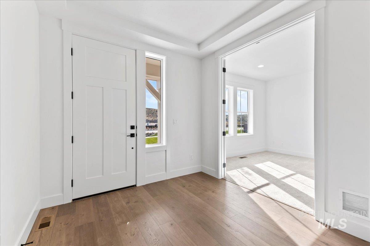 Foyer with light wood-style flooring