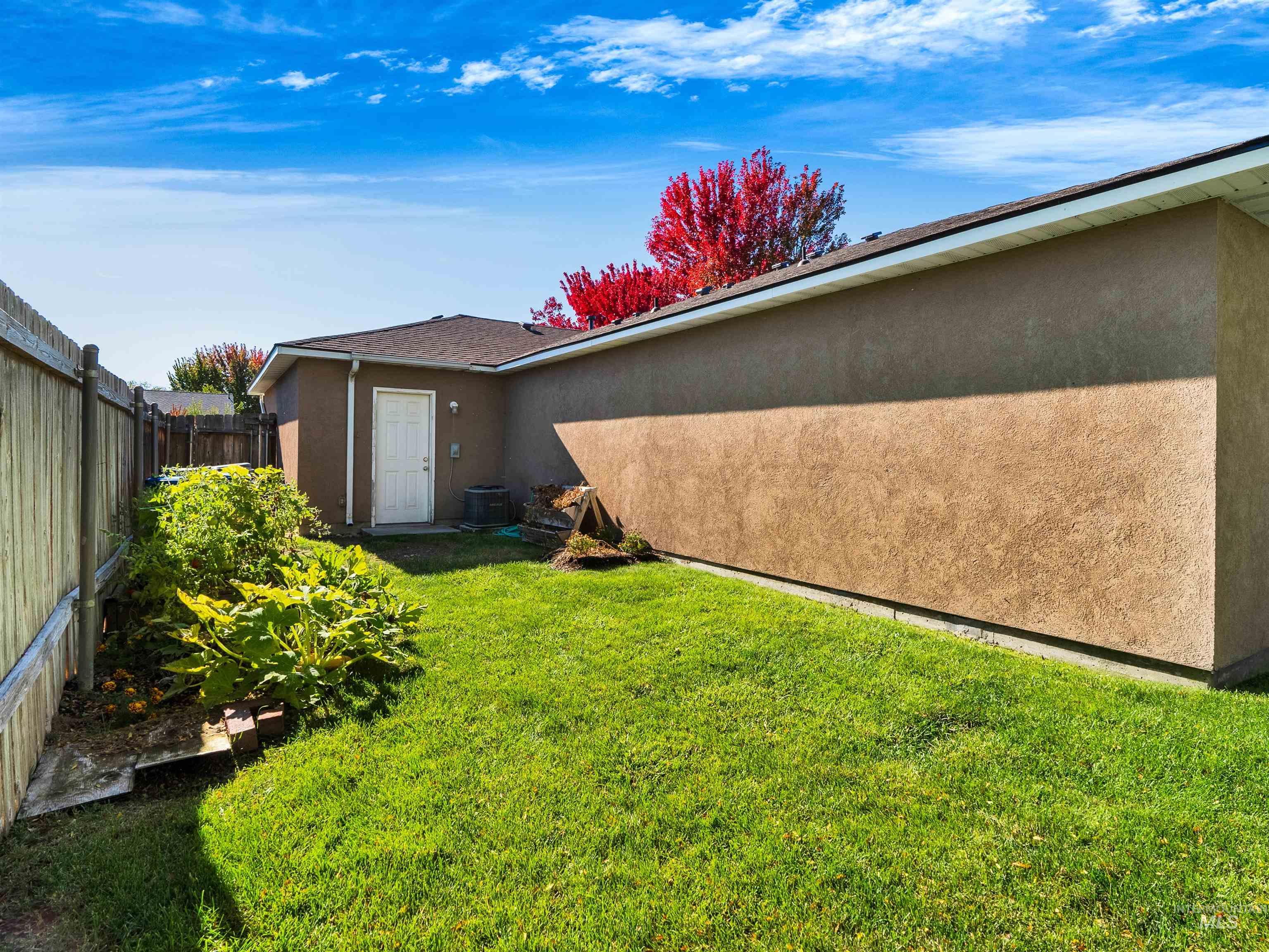 Back of house featuring stucco siding