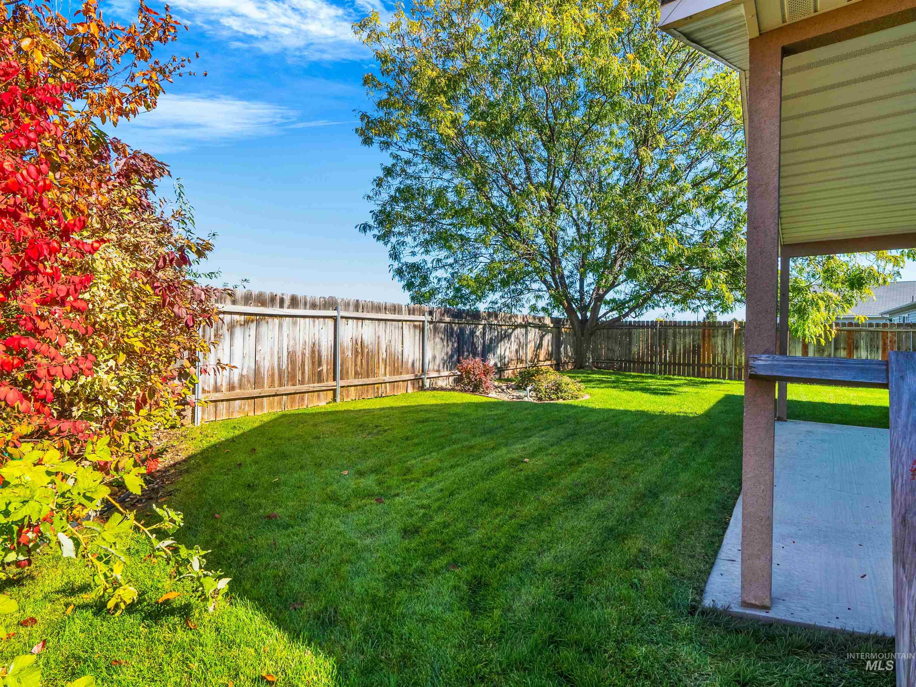 Fenced backyard with a patio