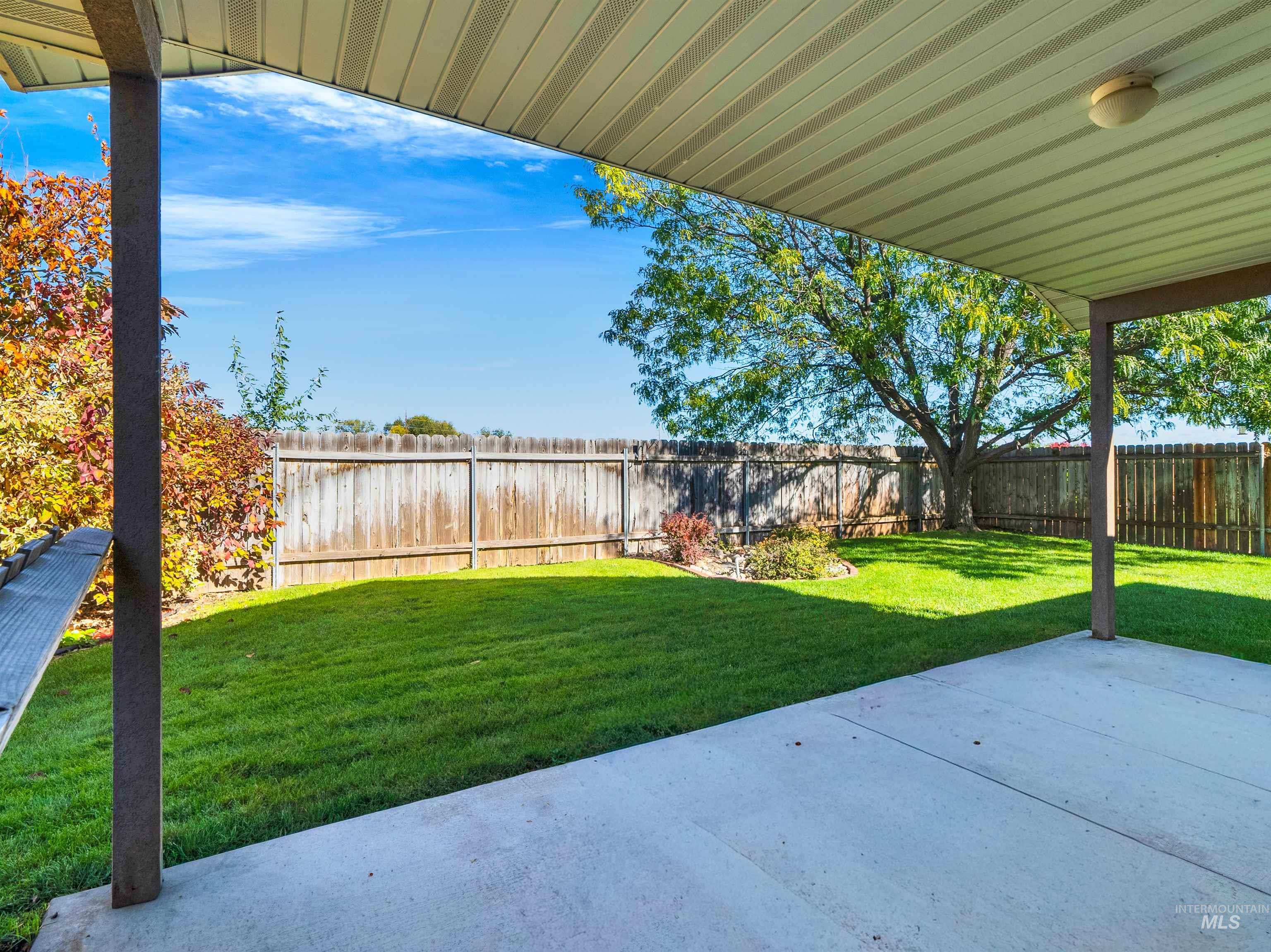 Fenced backyard with a patio area