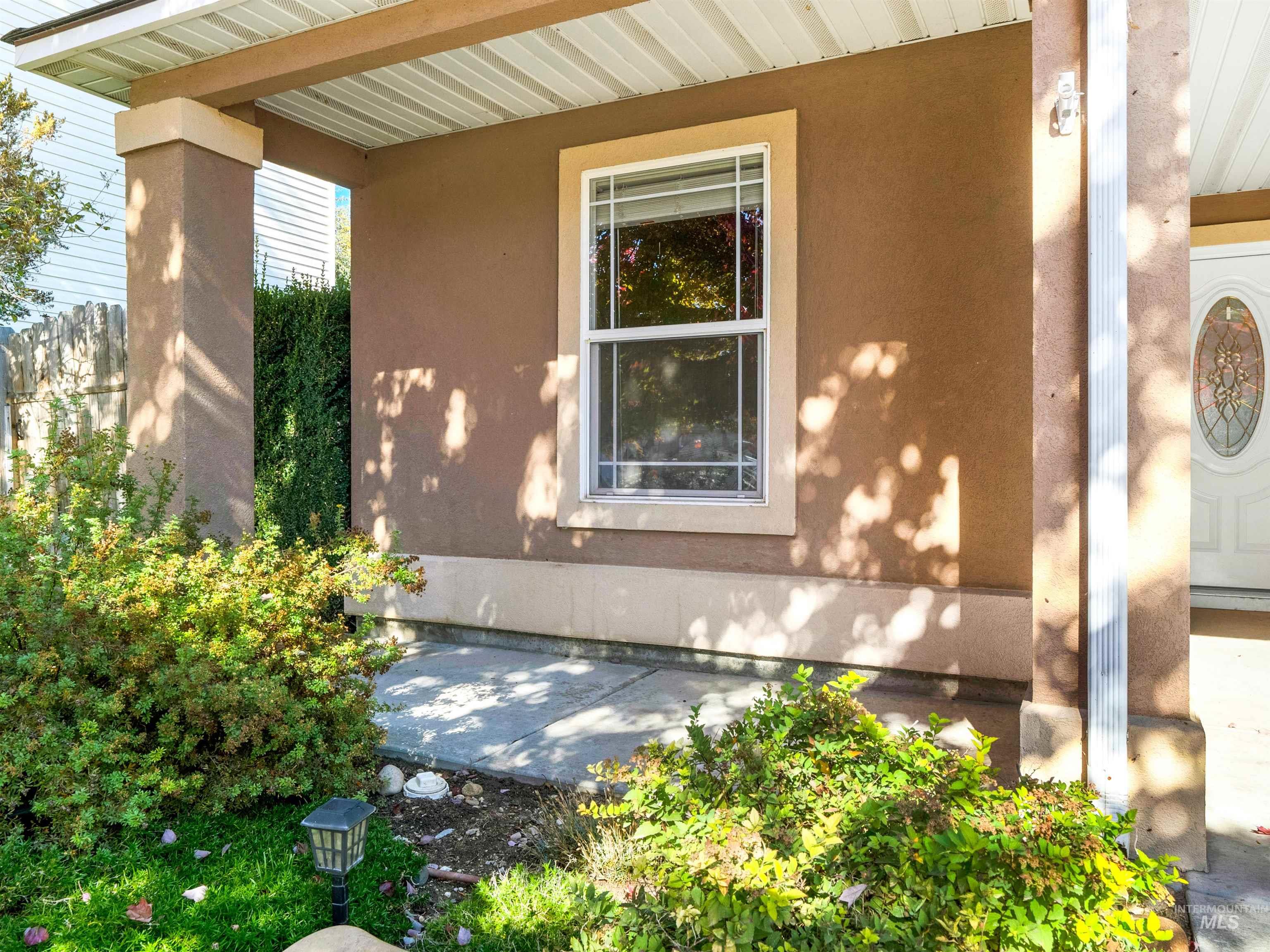 View of exterior entry with stucco siding