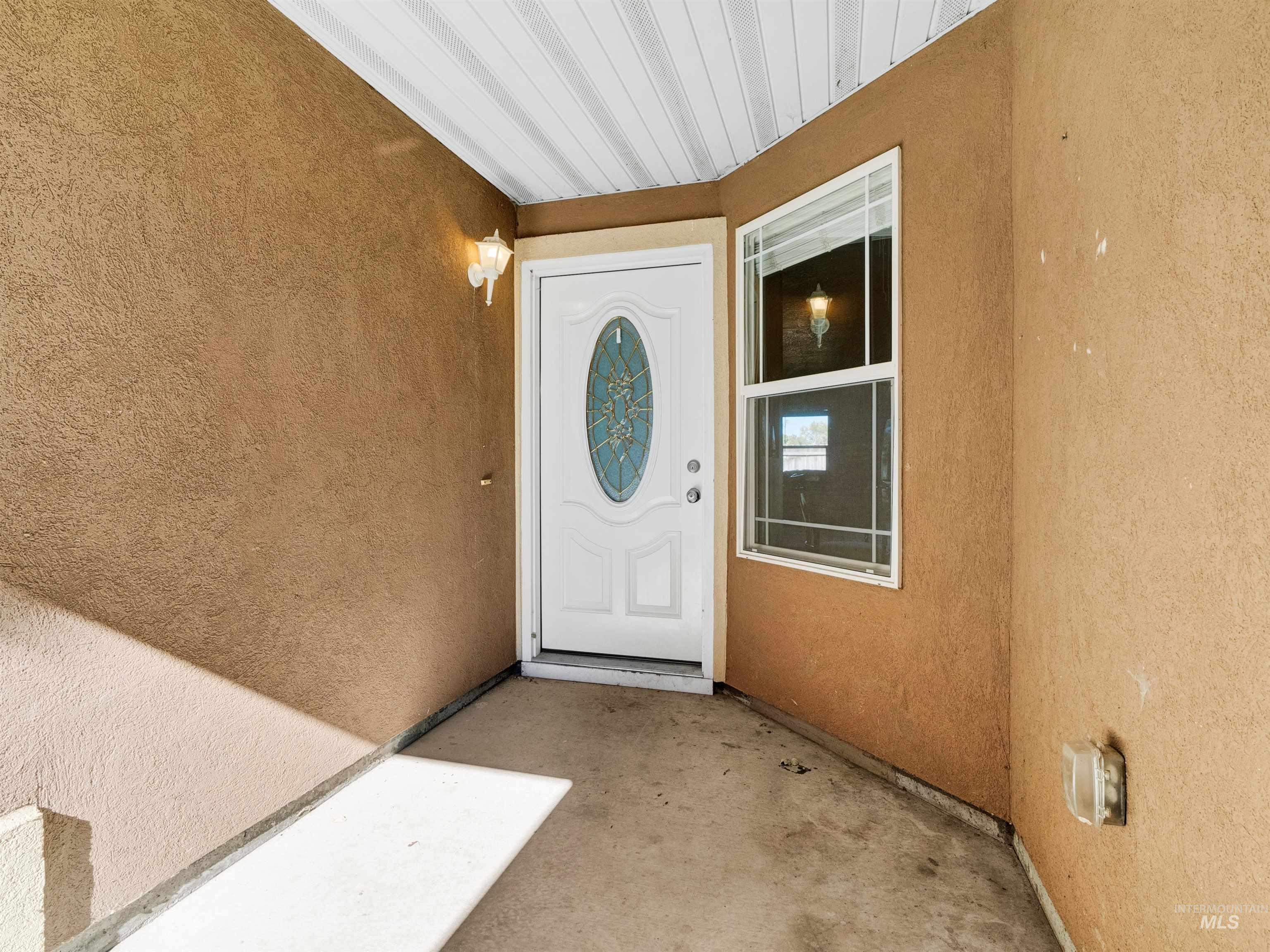 Doorway to property with stucco siding