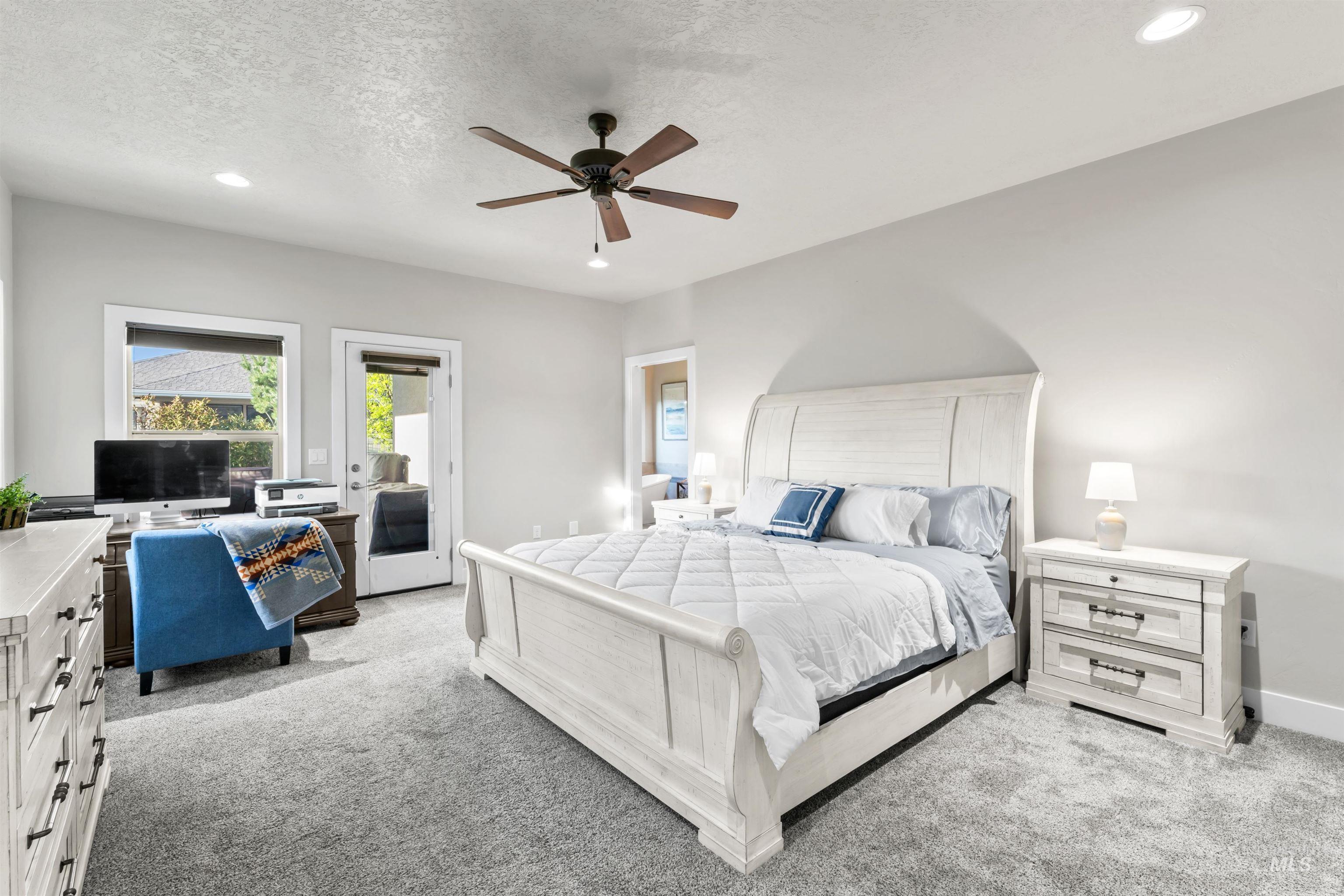 Bedroom with light carpet, recessed lighting, access to exterior, ceiling fan, and a textured ceiling