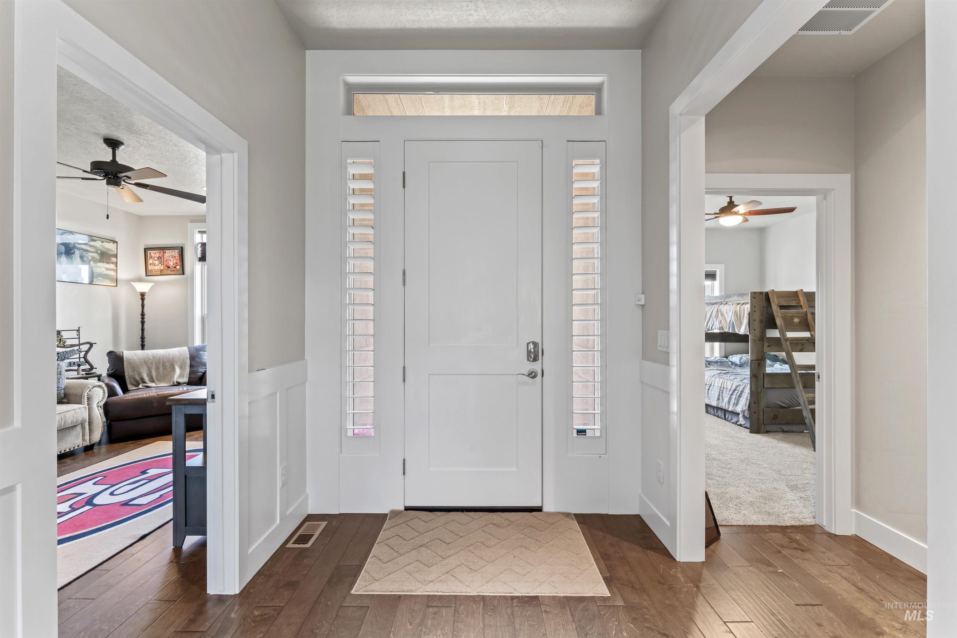 Foyer with ceiling fan, hardwood / wood-style flooring, and a textured ceiling