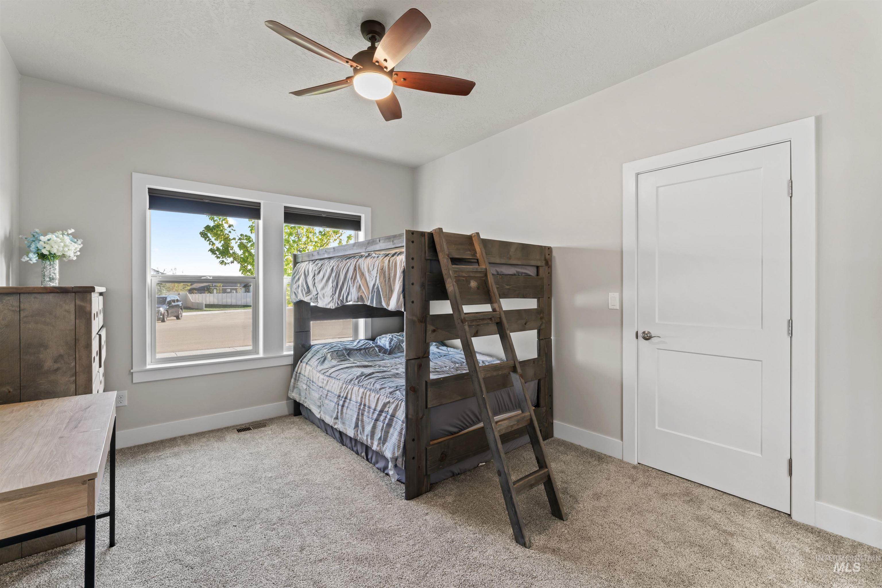 Bedroom featuring light colored carpet and ceiling fan