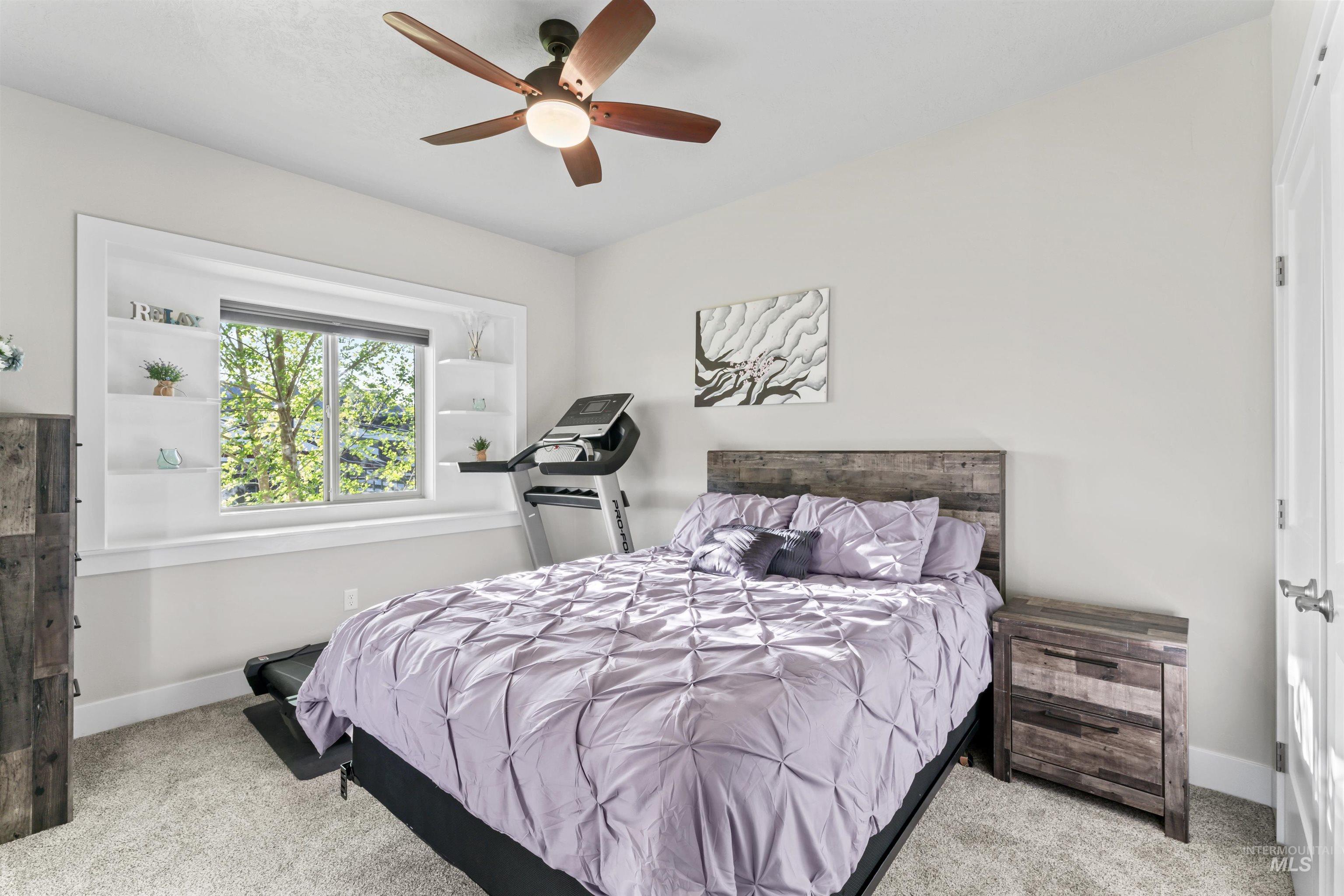 Bedroom featuring light carpet and a ceiling fan
