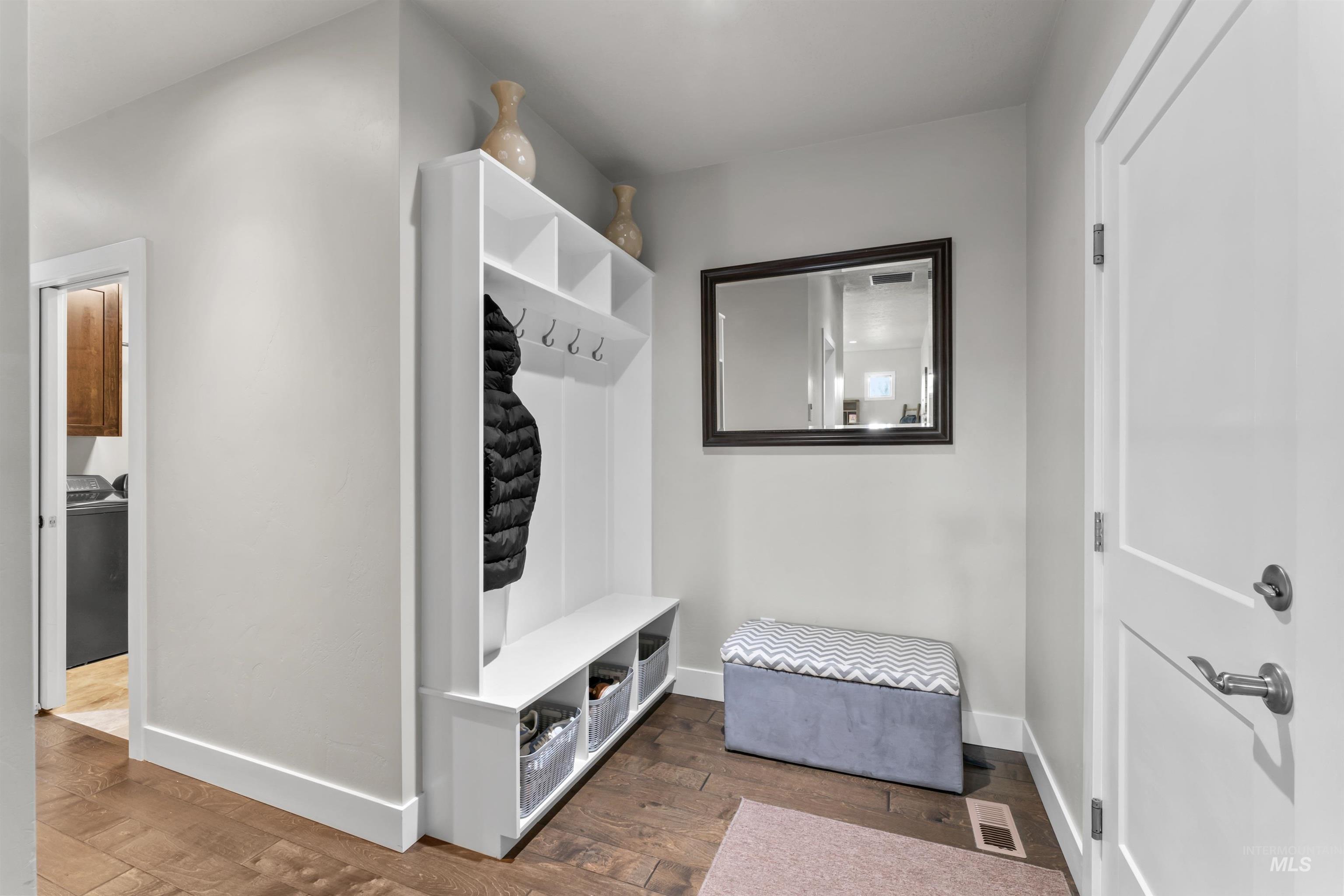 Mudroom featuring wood finished floors and baseboards