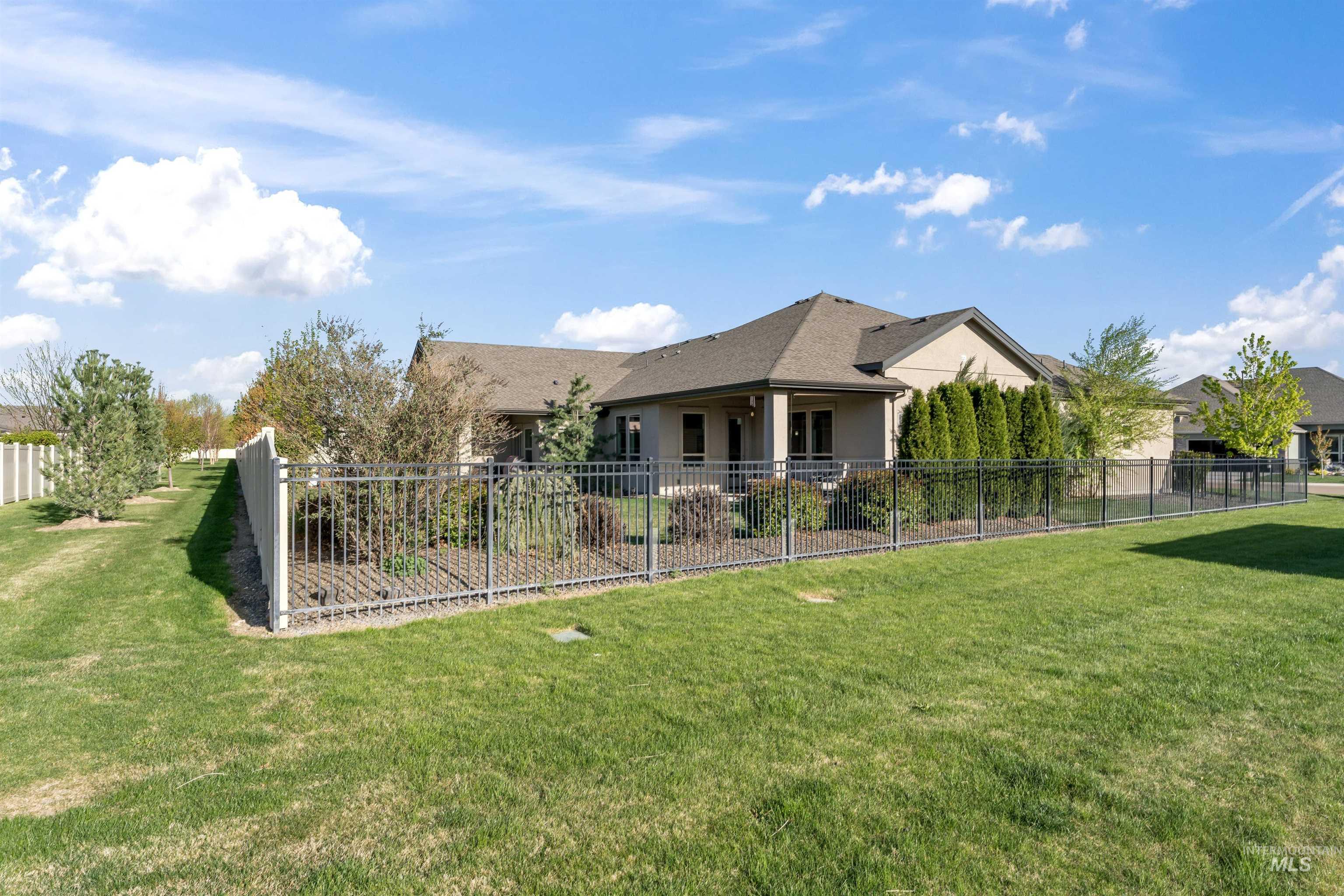 Rear view of property with a fenced backyard, stucco siding, and a shingled roof