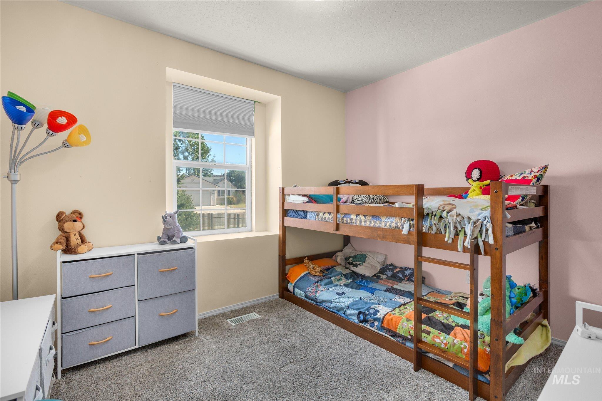 Bedroom with light carpet and baseboards