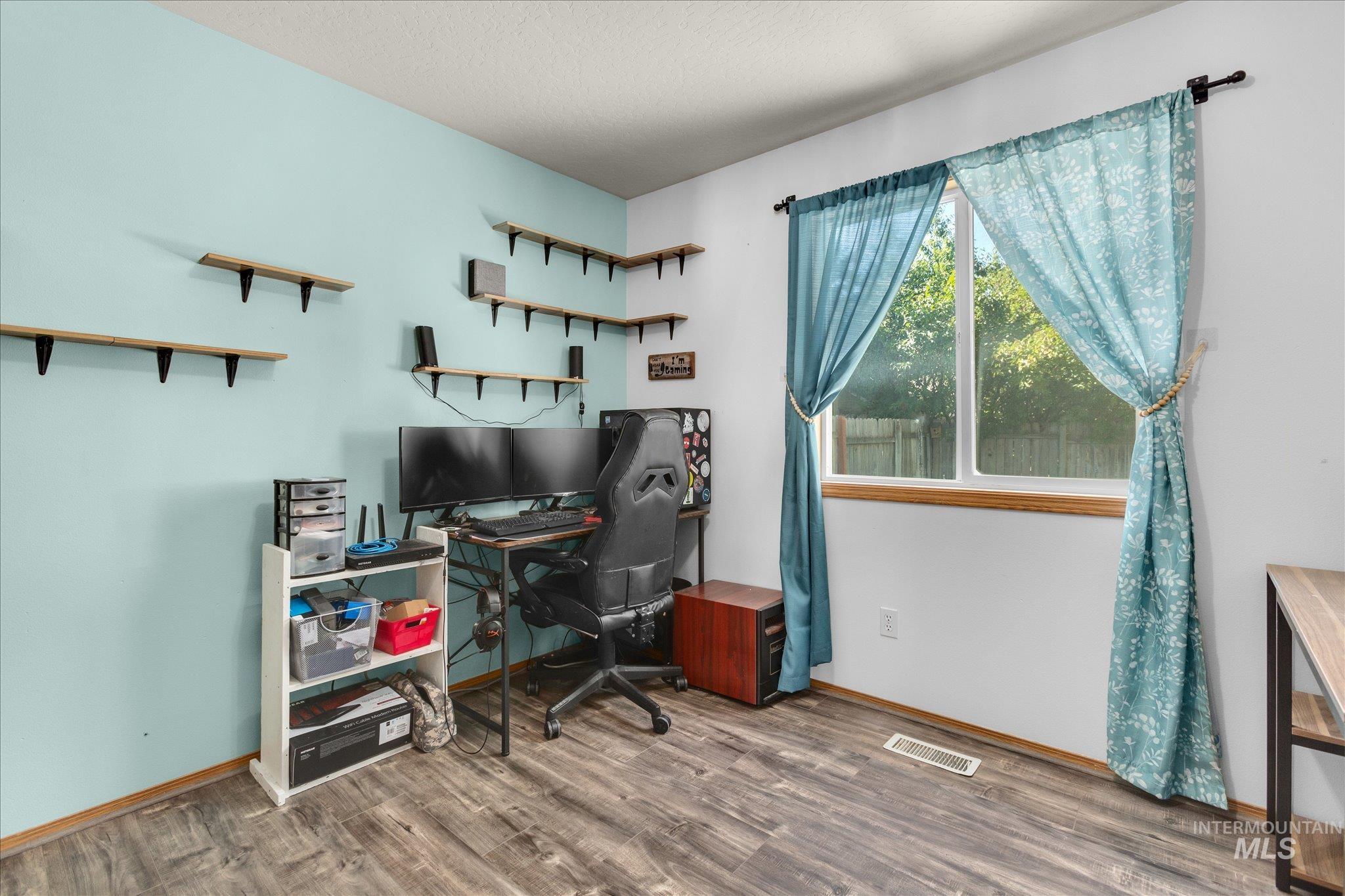 Office area featuring wood finished floors and baseboards